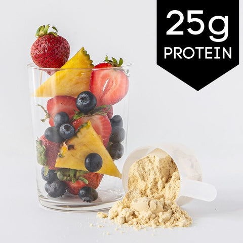 Ingredients for Pineapple Berry Protein Smoothie with pineapple chunks, strawberries, blueberries, banana slices, and a scoop of whey protein powder.