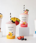All four Shake Please protein smoothies blended and ready to drink — strawberry banana, chocolate peanut butter banana, vanilla berry, and pineapple berry.