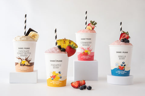 All four Shake Please protein smoothies blended and ready to drink — strawberry banana, chocolate peanut butter banana, vanilla berry, and pineapple berry.